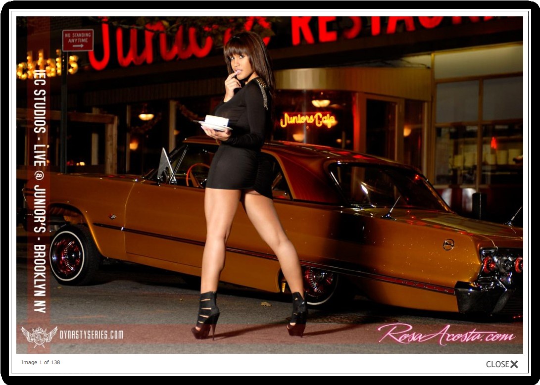 woman posing by classic car