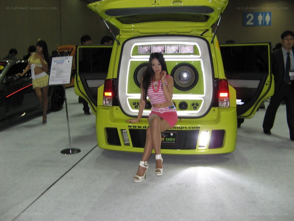 Woman posing by custom car