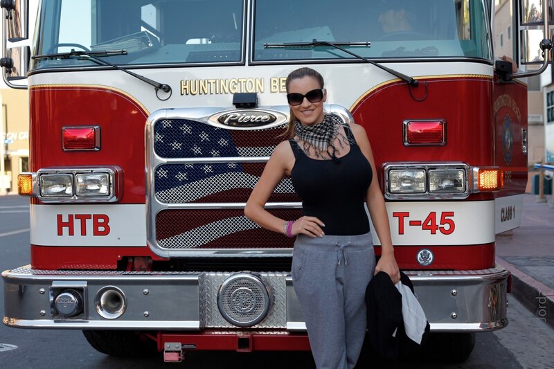 woman posing by fire truck