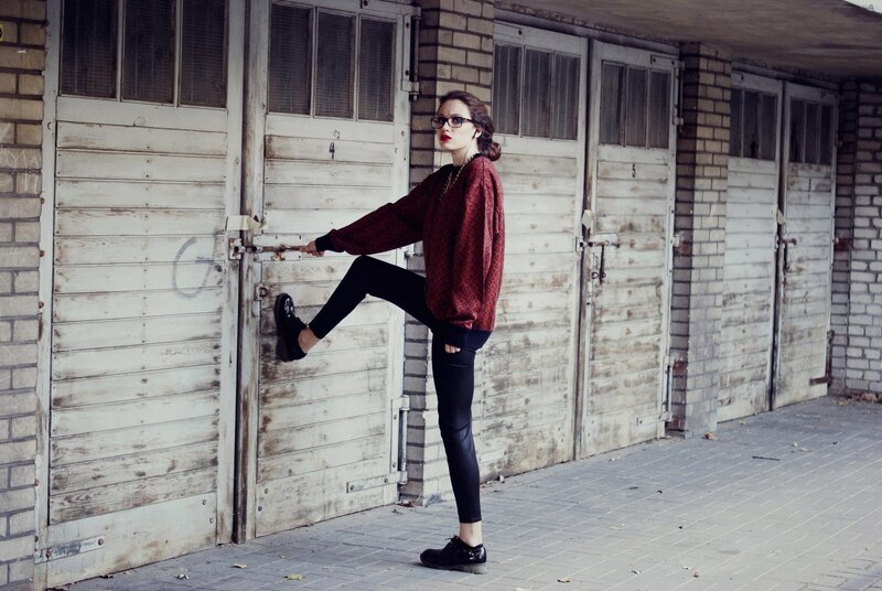 woman posing by garage doors