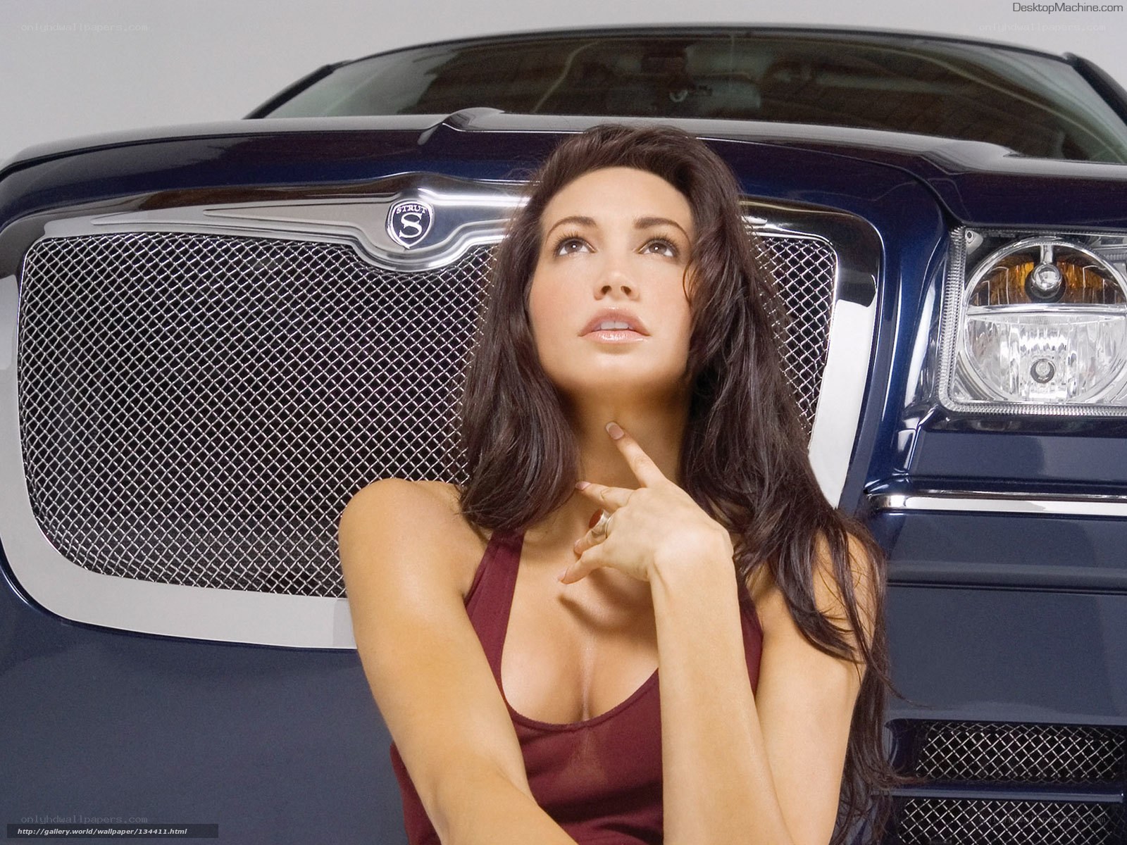 woman posing by luxury car