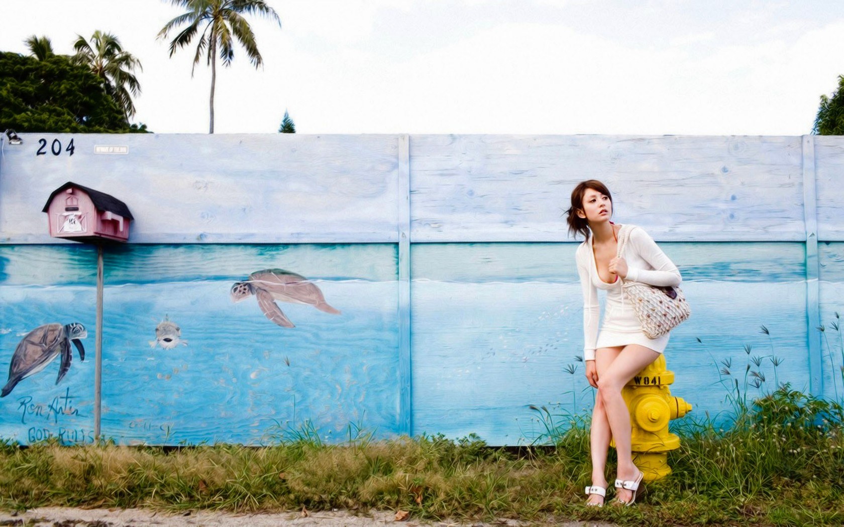 Woman posing by mural