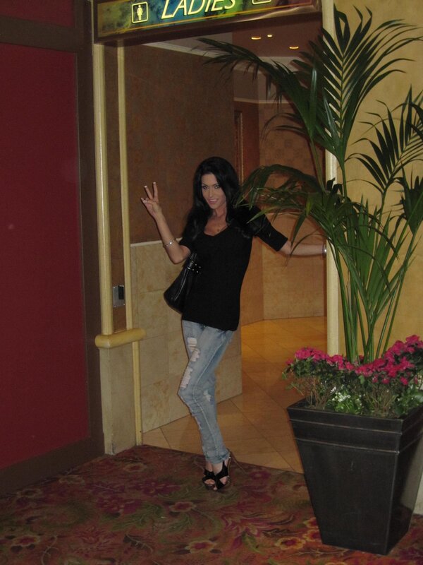 Woman posing by restroom entrance