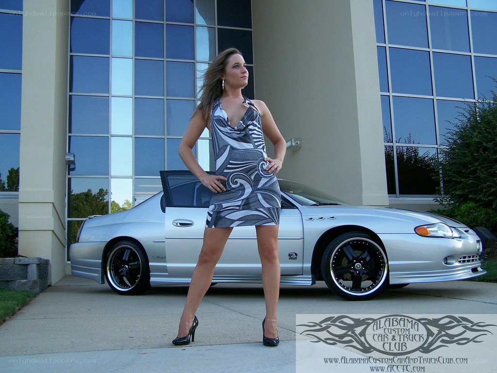 woman posing by silver car