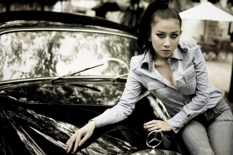 woman posing by vintage car