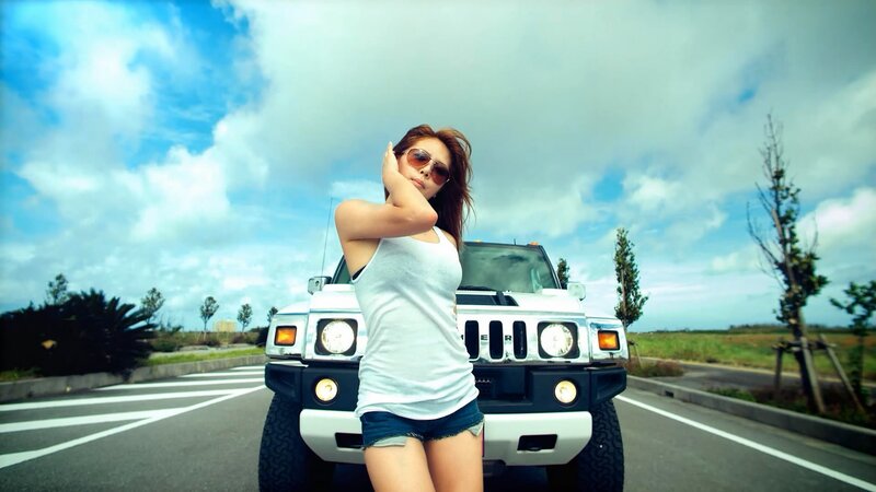 woman posing by white hummer