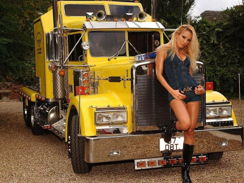 Woman posing by yellow truck