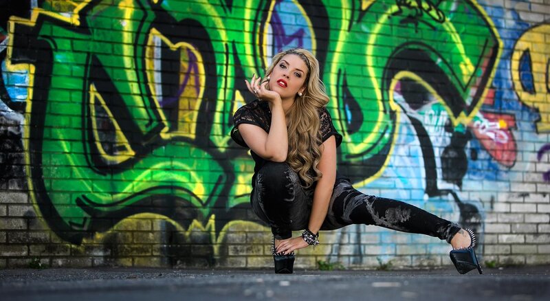woman posing in front of graffiti
