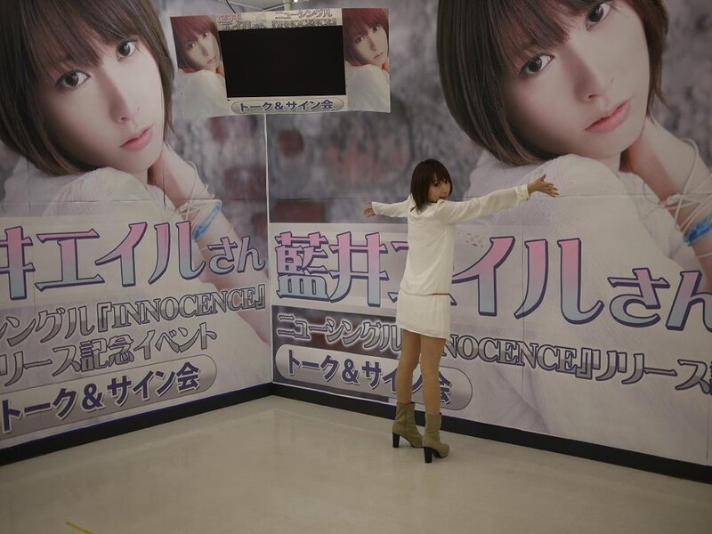 Woman posing in front of promotional banners