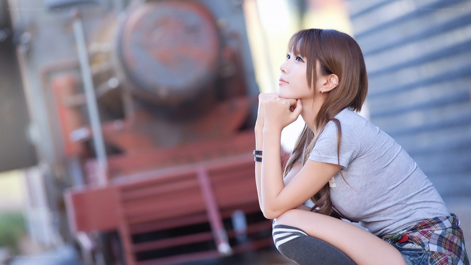 woman posing near a train