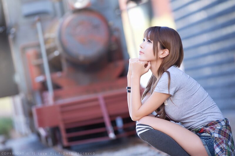 woman posing near train