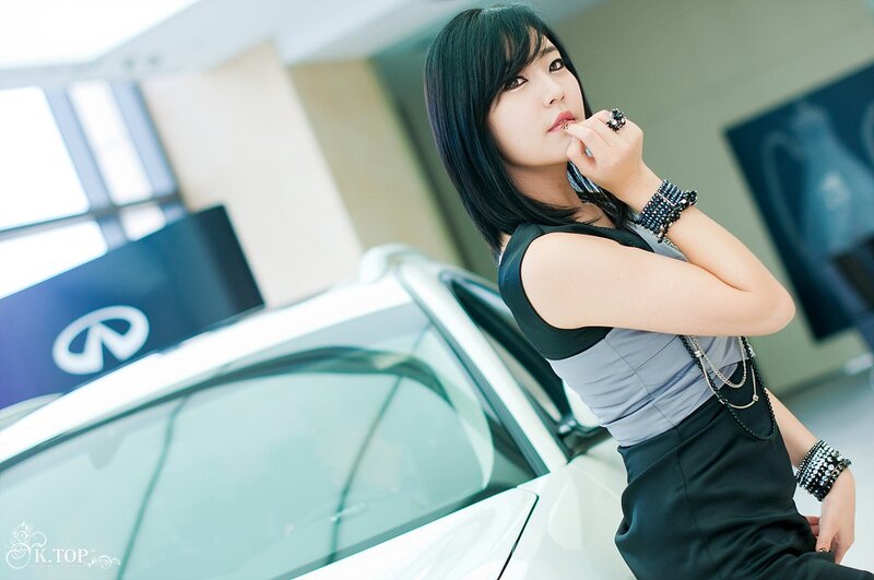 woman posing near white car