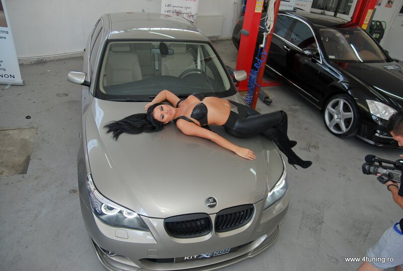 Woman posing on car hood