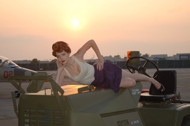 woman posing on military vehicle