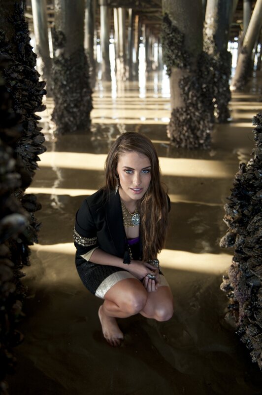 woman posing under pier