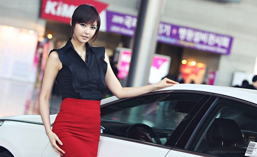 Woman posing with a car
