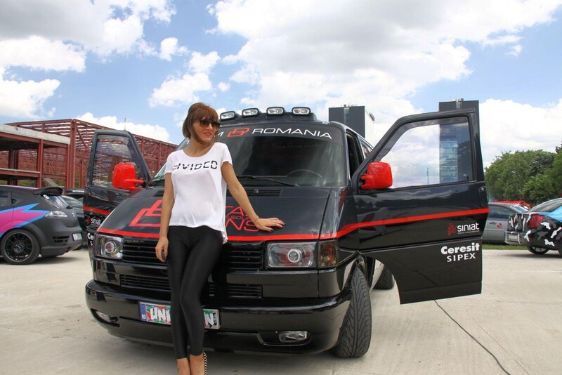 Woman posing with a customized van