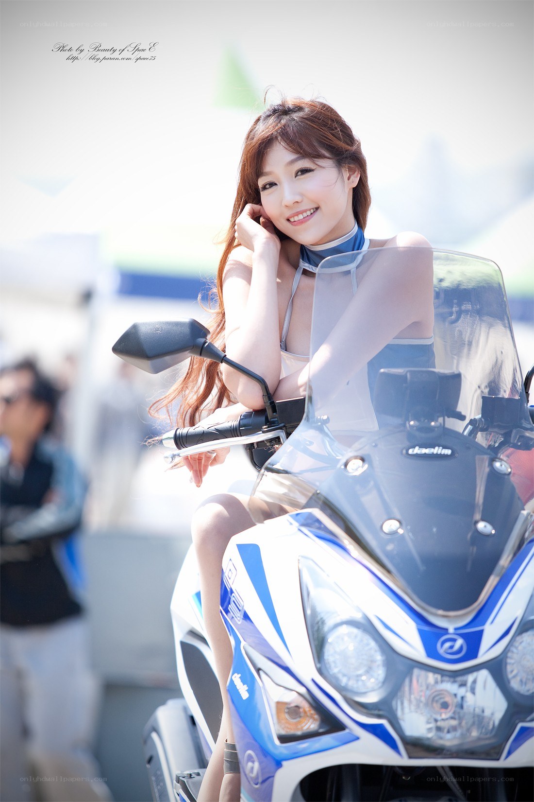 Woman posing with a motorcycle