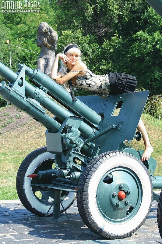 Woman posing with artillery gun