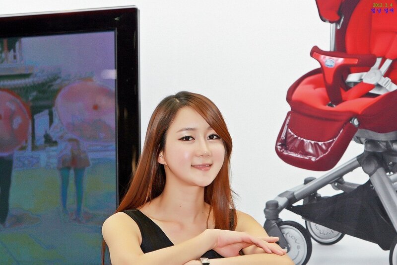 Woman posing with baby stroller