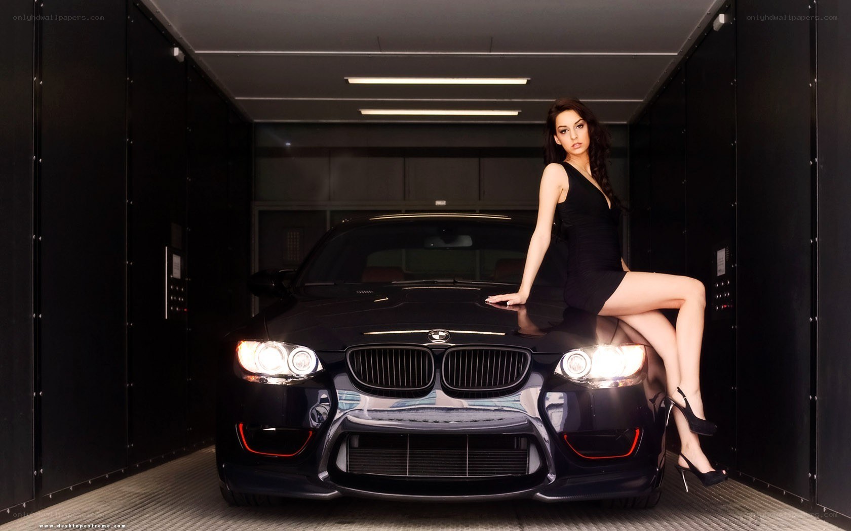 Woman posing with black BMW