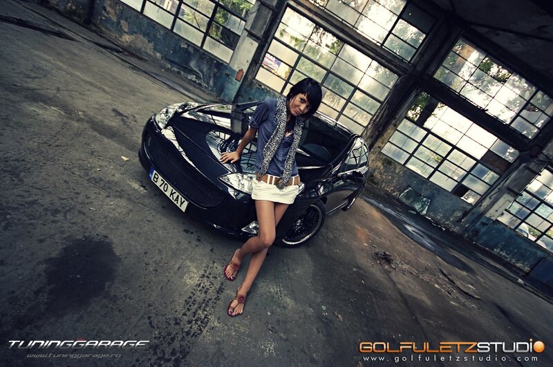 woman posing with black car