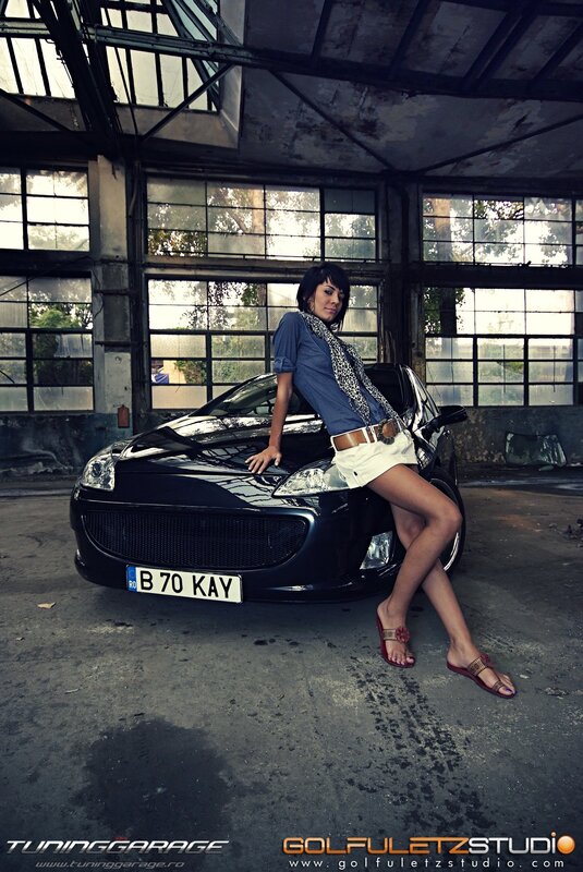 Woman posing with black car