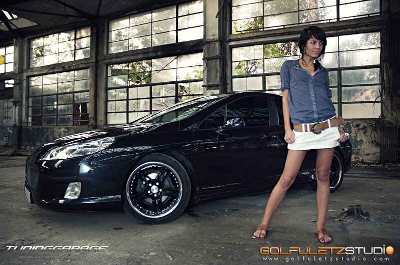woman posing with black car