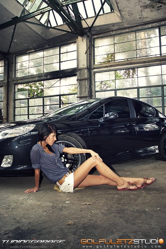Woman posing with black car