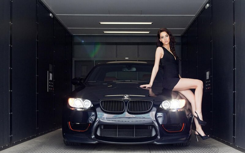 woman posing with black car