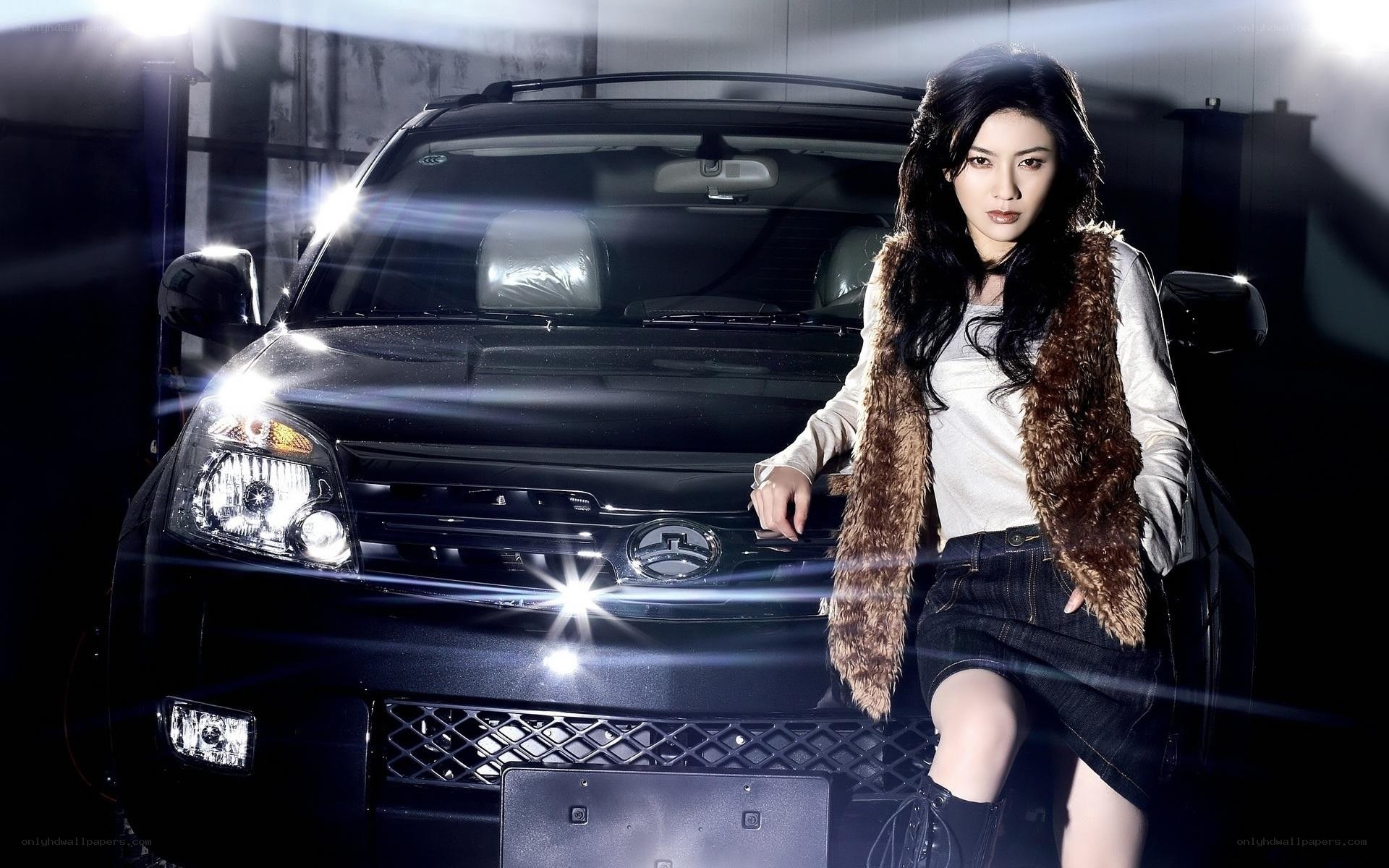 woman posing with black car
