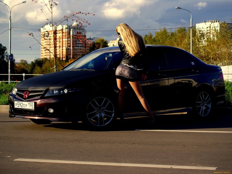 Woman posing with black car