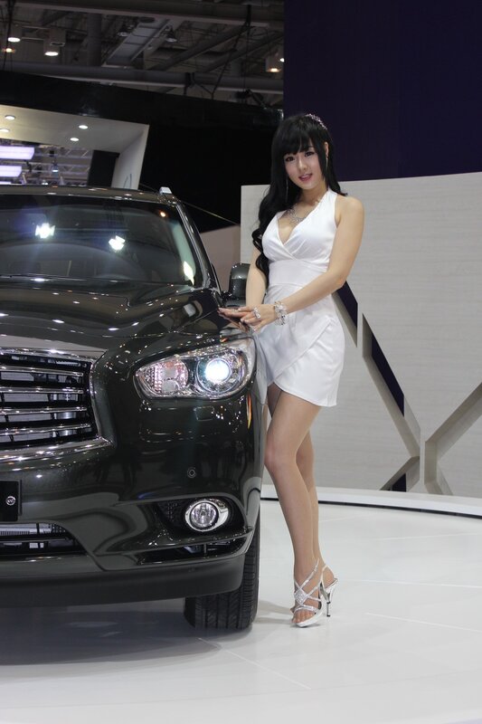 Woman posing with black car