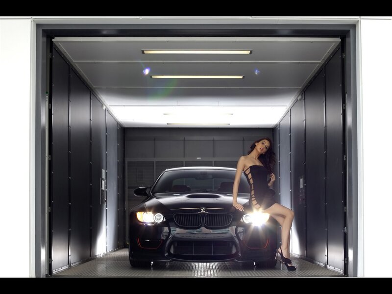 woman posing with black car