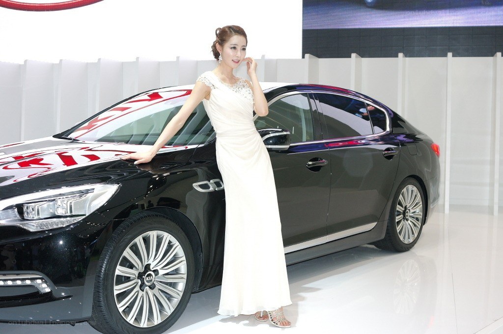 Woman posing with black sedan
