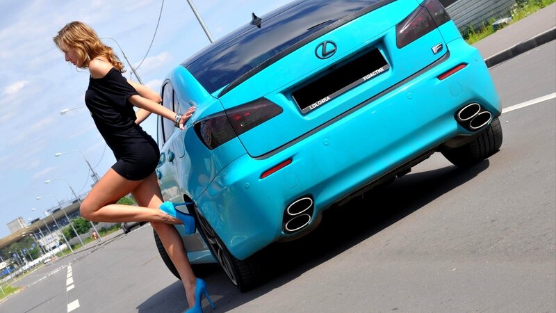 woman posing with blue car