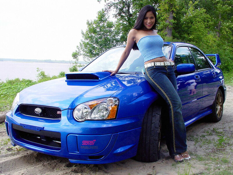 woman posing with blue car