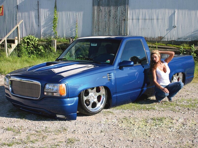 woman posing with blue truck