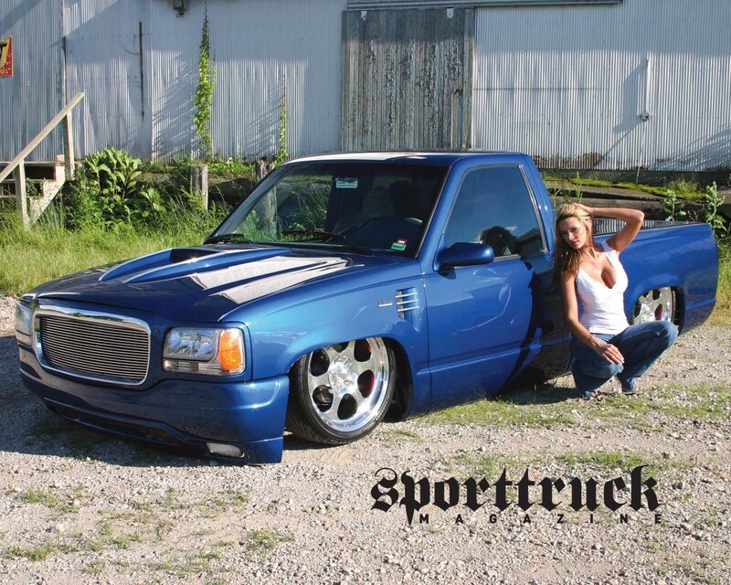 woman posing with blue truck