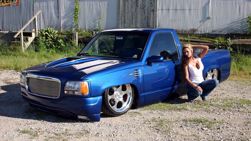 woman posing with blue truck