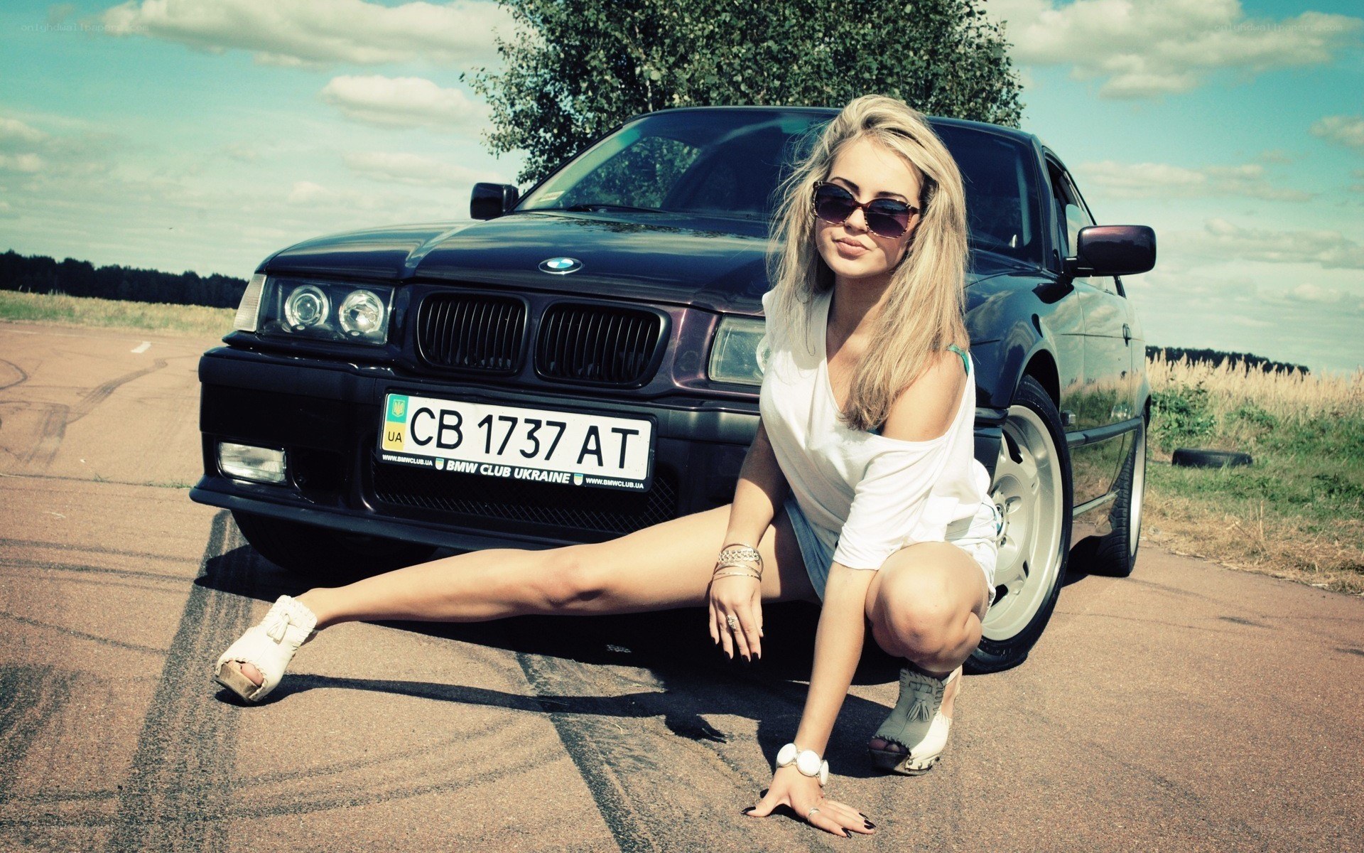woman posing with bmw car