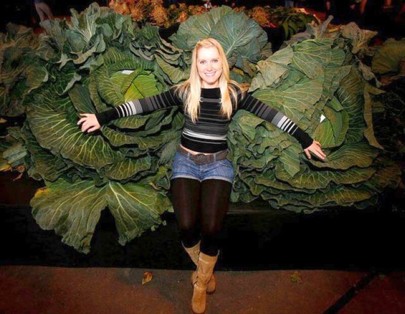 woman posing with cabbages