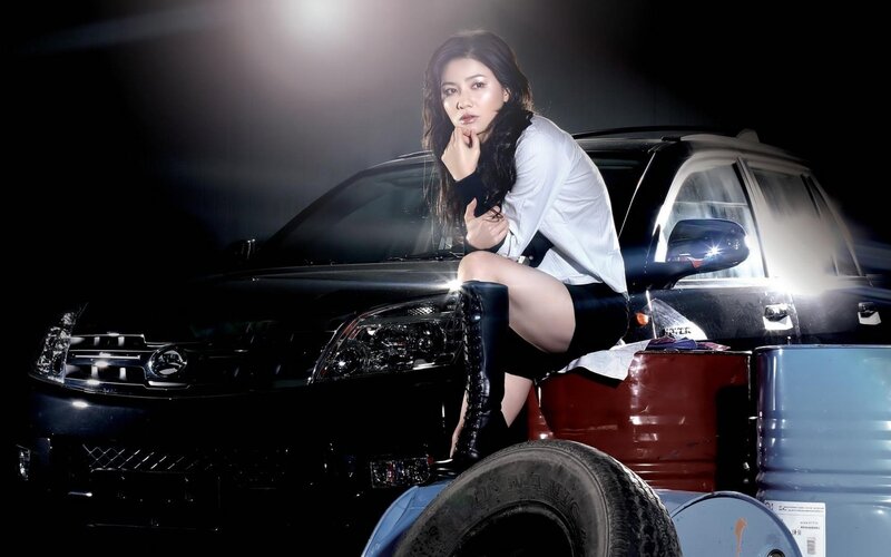 woman posing with car