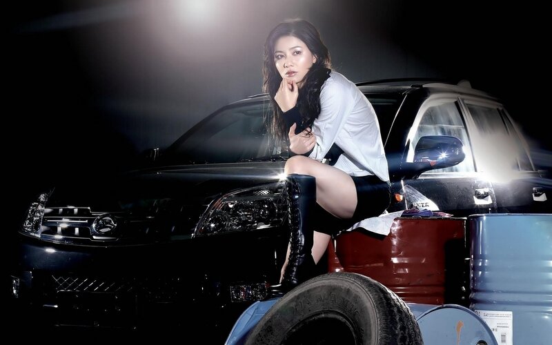 woman posing with car