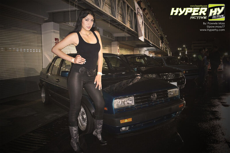 Woman Posing with Car — Black, Dramatic, Night, Photograph, Crowd