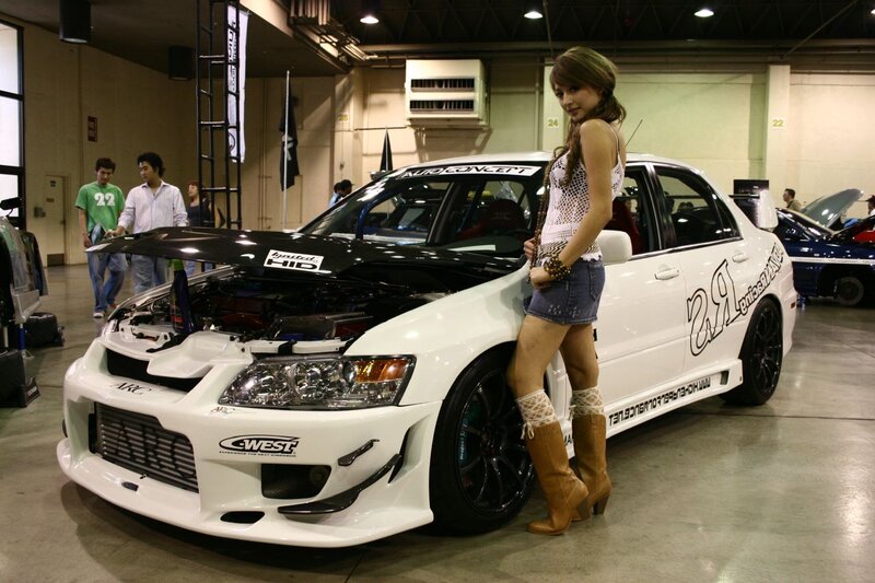 Woman Posing with Car — White, Neutral, Photograph, Show Floor