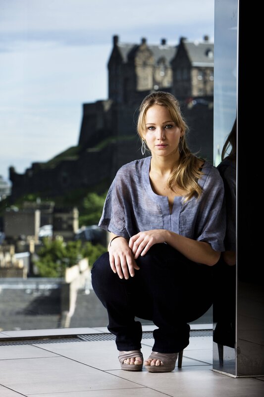 woman posing with castle in background