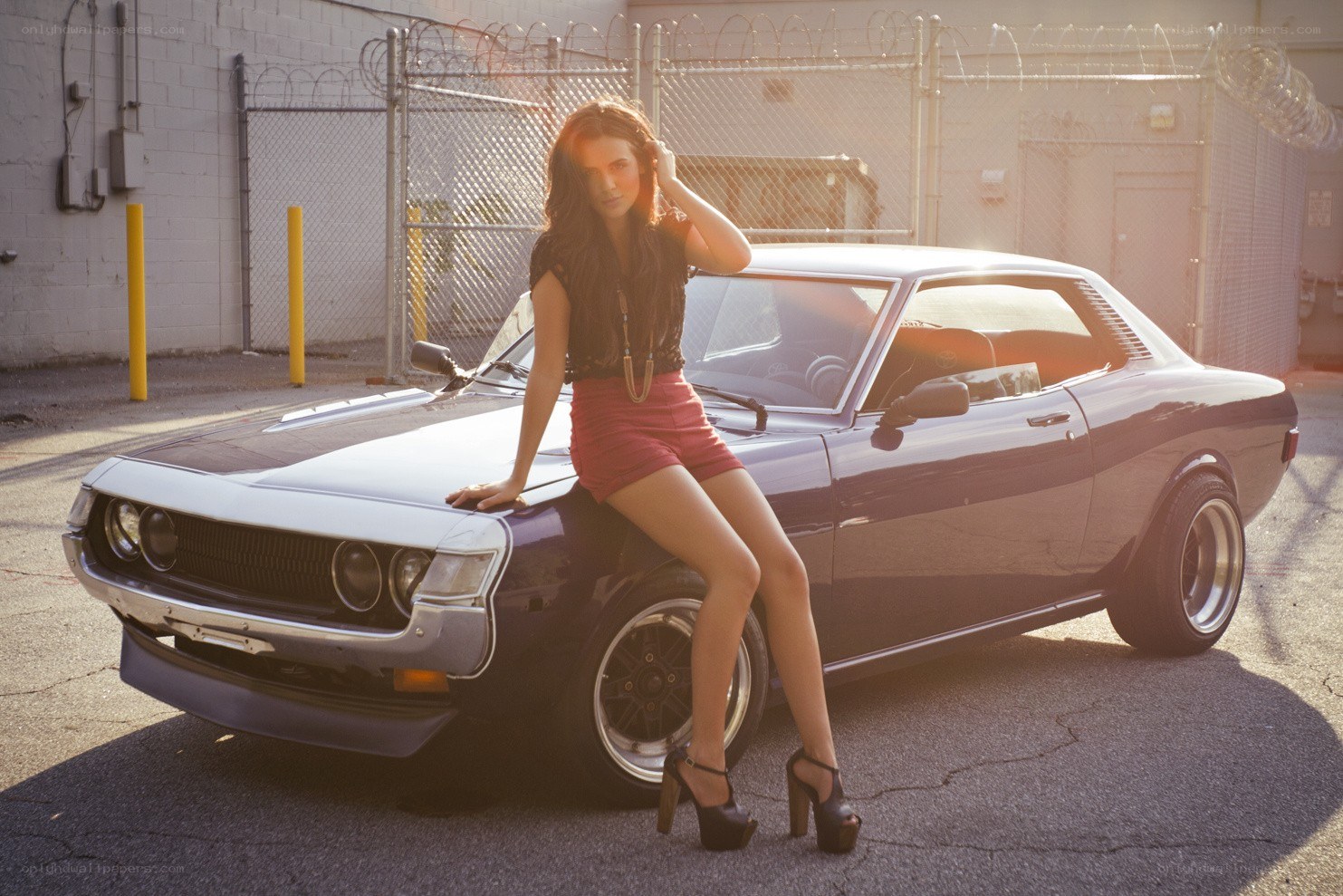 woman posing with classic car