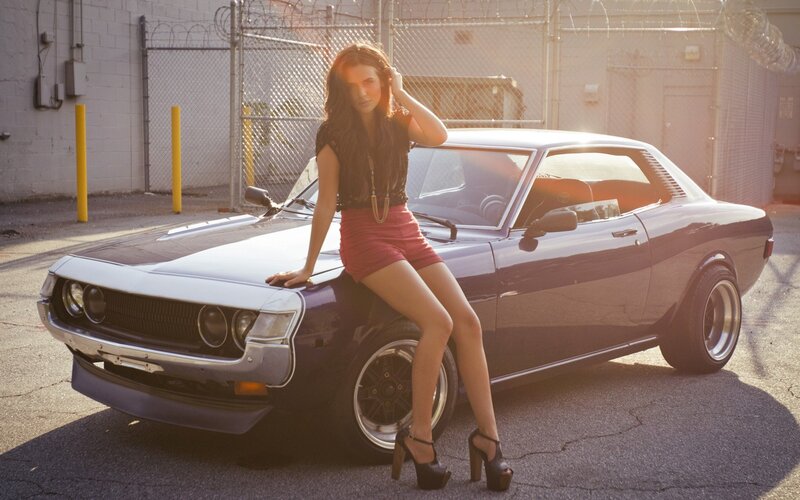 woman posing with classic car