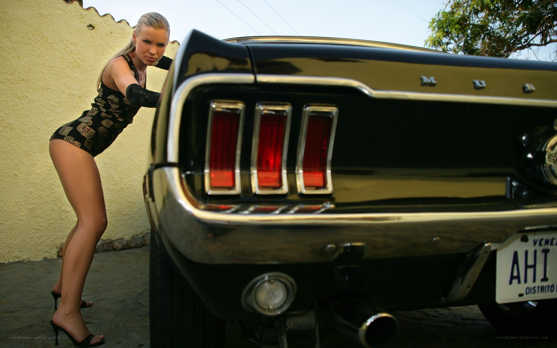 woman posing with classic car
